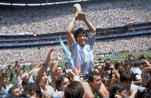 ** FILE ** Argentina's Diego Maradona, holding up the trophy, is carried on shoulders as he celebrates at the end of the World Cup soccer final game against West Germany at the Atzeca Stadium, in Mexico City, in this June 29, 1986, file photo. Argentina won 3-2. Maradona and Argentinean coach Carlos Bilardo have been asked to lead Argentina by Julio Grondona, head of the Argentine Football Association, Tuesday, Oct. 28, 2008. (AP Photo/Carlo Fumagalli, file)